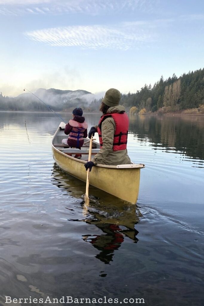 Mother and daughter canoeing in winter
